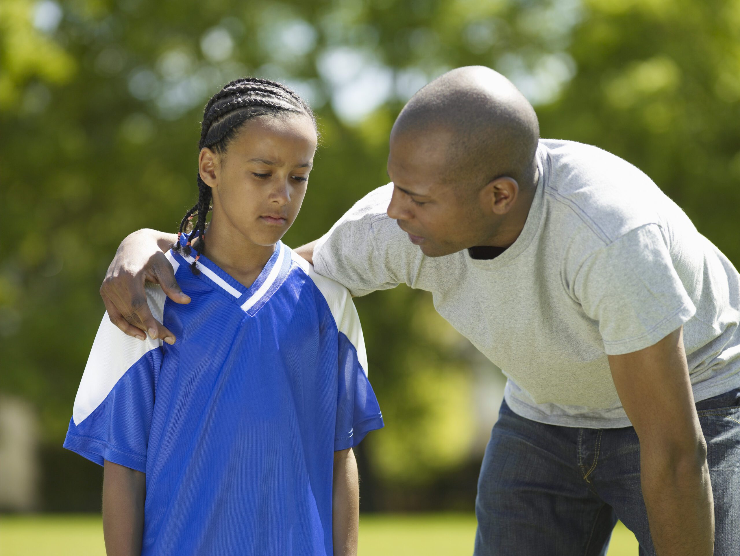 Sports parent encouraging a young athlete during the beginning with new coach 