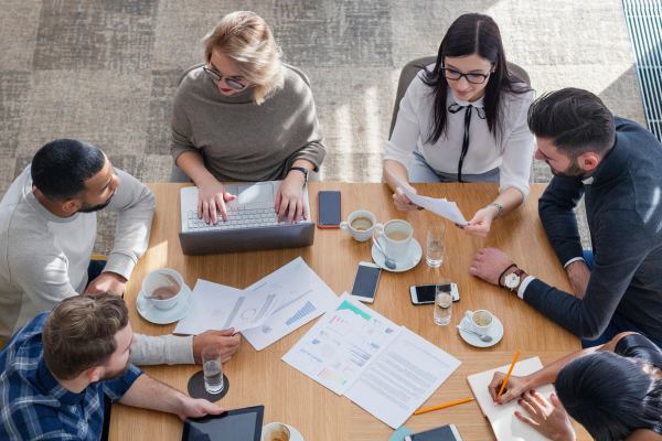Group of GenZ professionals collaborating in a modern workplace, showcasing workplace skills GenZ brings to the table.
